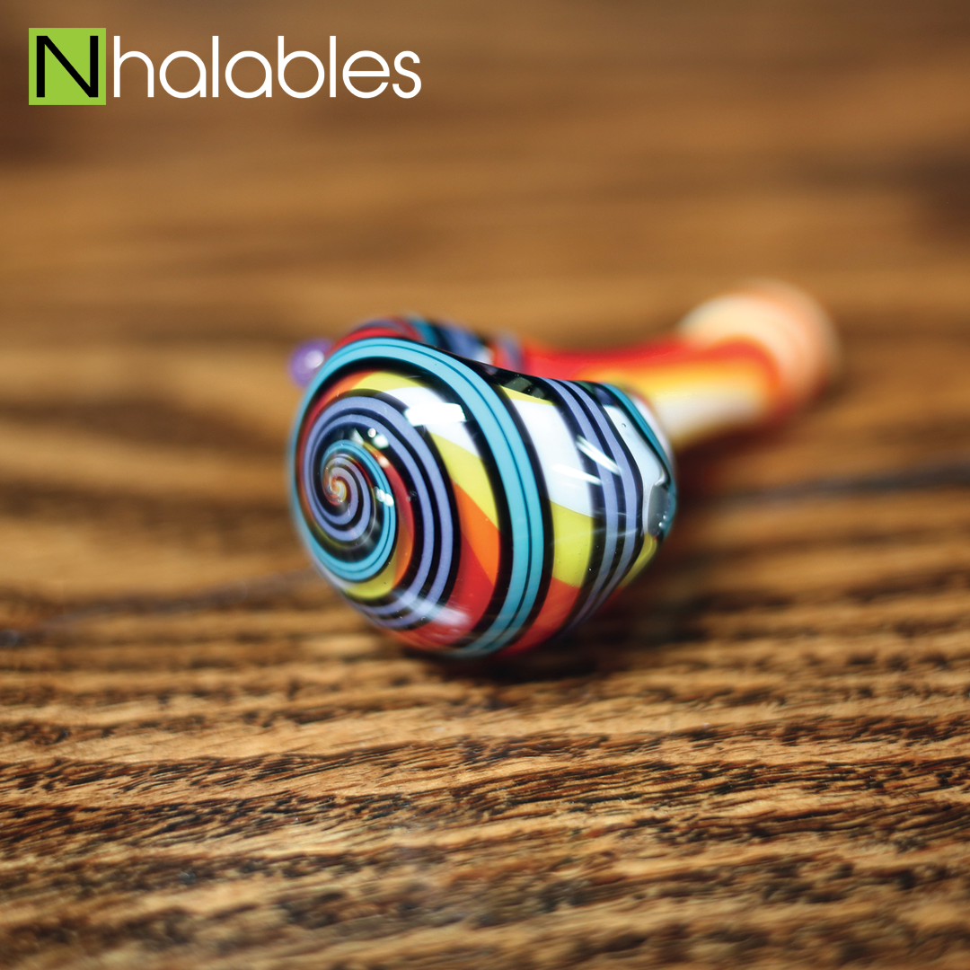 Nhalables Social Post showing a Jem Glass Rainbow Linework Hand Pipe sitting on a wooden shelf.