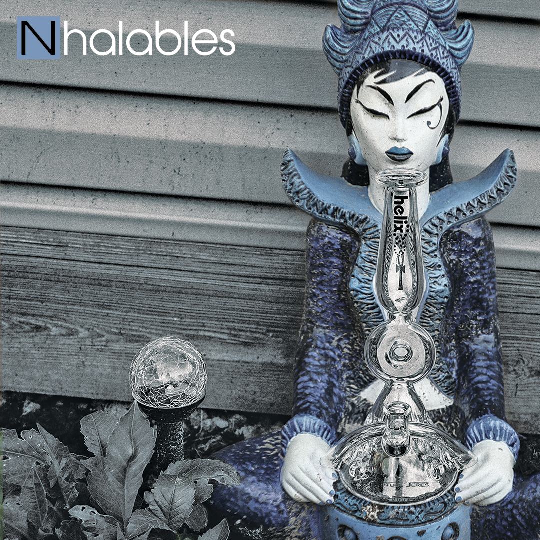 Nhalables Social Post Showing an American Helix + Charli Glass (texas) Kronos Waterpipe from their Titan Series Sitting in a lawn Sculpture