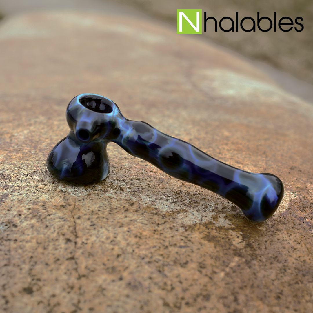 Nhalables Social Post Showing a BTS Glass Marbled Hammer Dry Pipe sitting on a rock