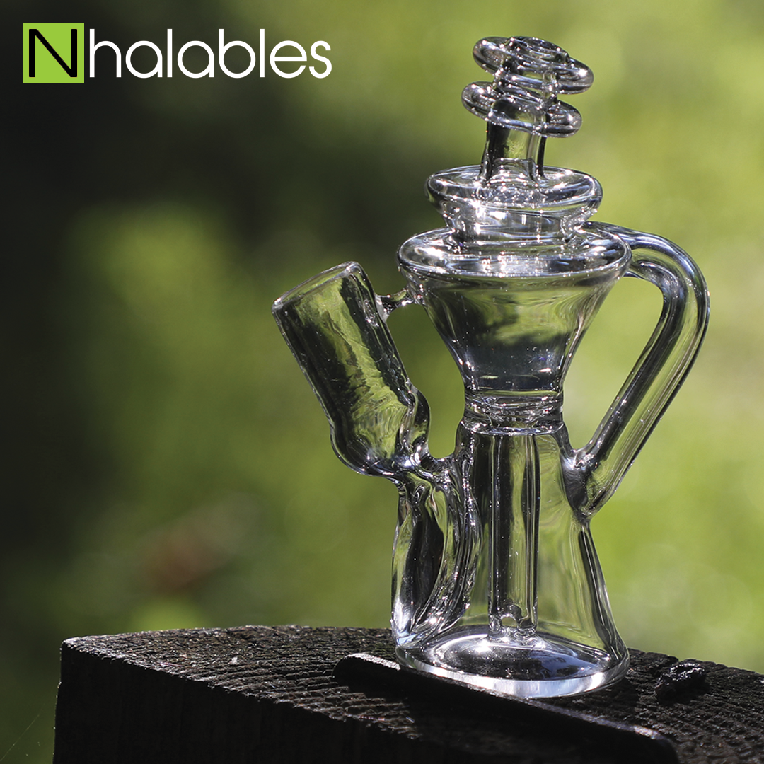 Nhalables Social Image showing a Cleveland, Ohio based artist Davenci Glass 5 inch gill seal recycler oil rig sitting on a wooden post with blurry trees in the background
